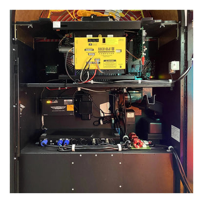 Inside view of a arcade machine with visible components and wiring.
