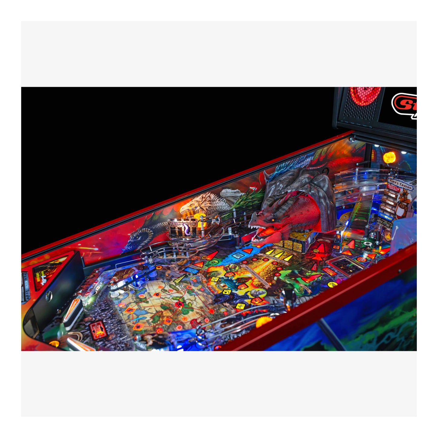 Pinball machine with colorful artwork and lights on a black background