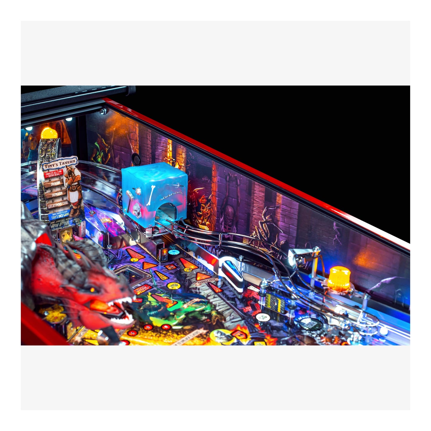 Close-up of a pinball machine with colorful lights and details.