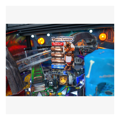 Close-up of a pinball machine with colorful artwork and a blue player figure.