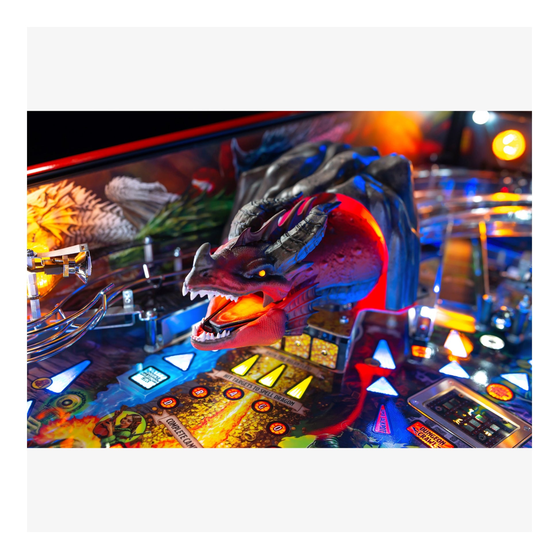 Close-up of a dragon figure on a pinball machine with colorful lights.