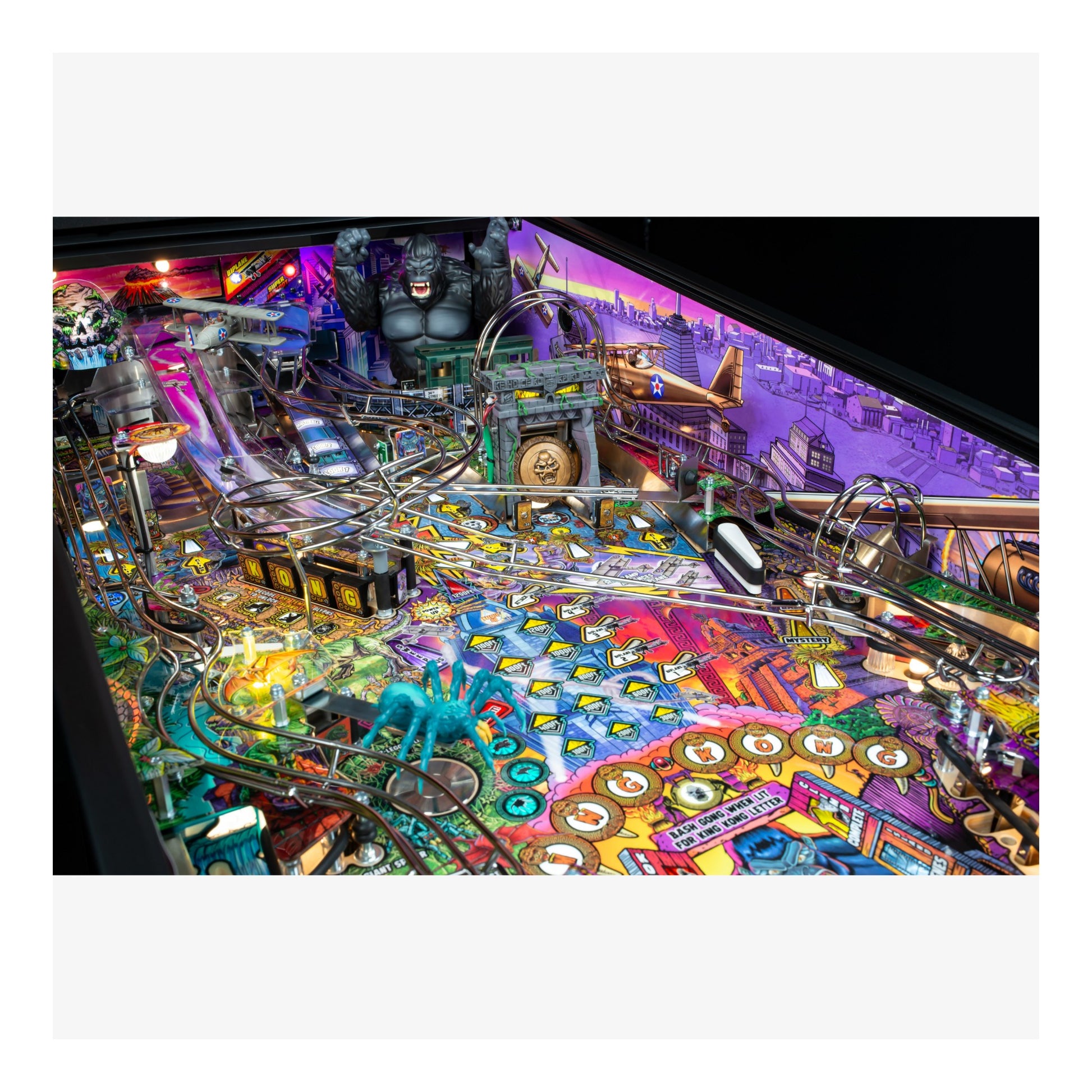 Colorful pinball machine with various elements and lights on a white background