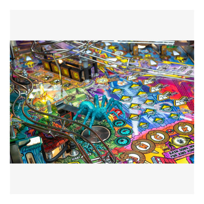 Colorful pinball machine with a blue spider figure on a white background
