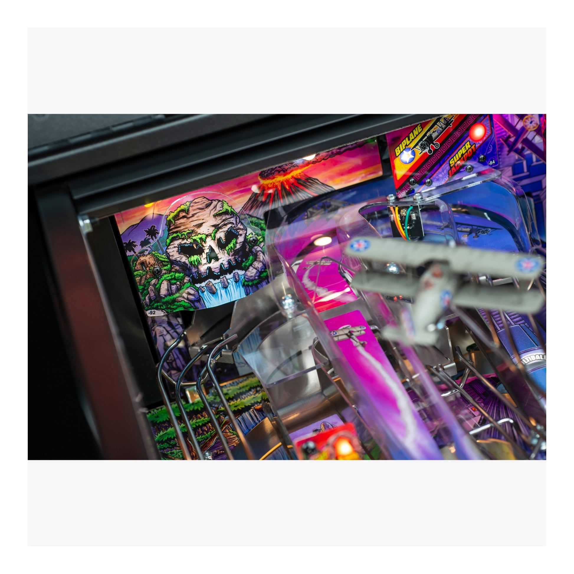 Close-up of a colorful pinball machine with vibrant graphics and lights.