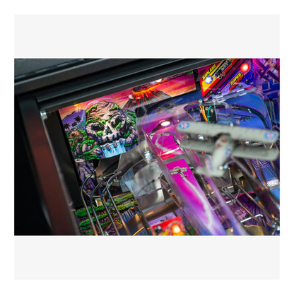 Close-up of a colorful pinball machine with vibrant graphics and lights.