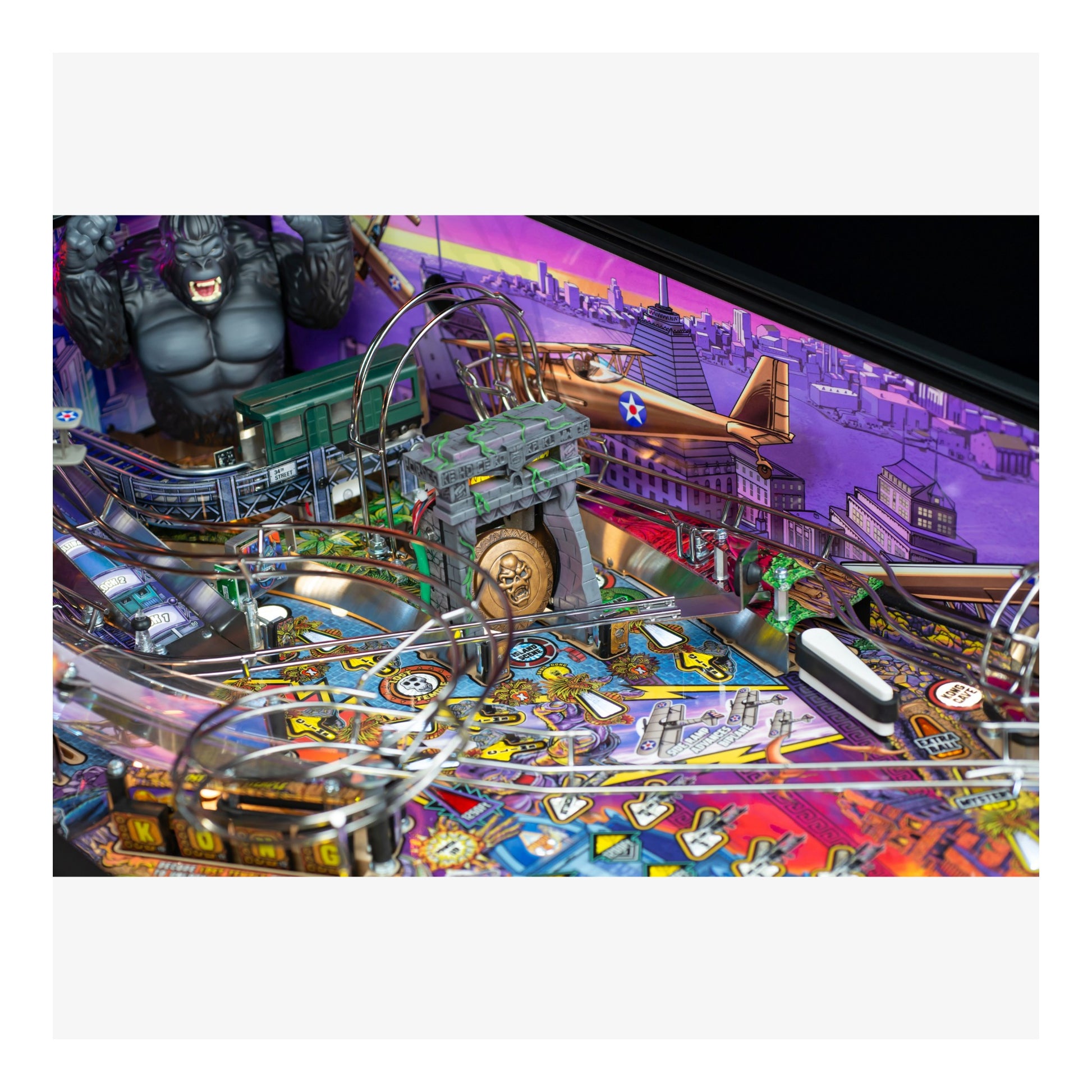 Pinball machine with colorful design and various elements on a white background