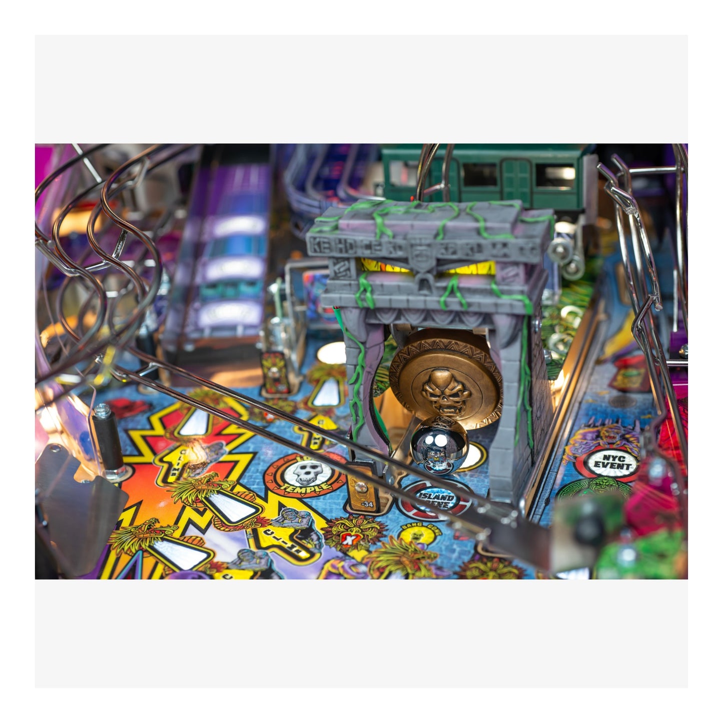 Close-up of a colorful pinball machine with vibrant graphics and mechanical components.