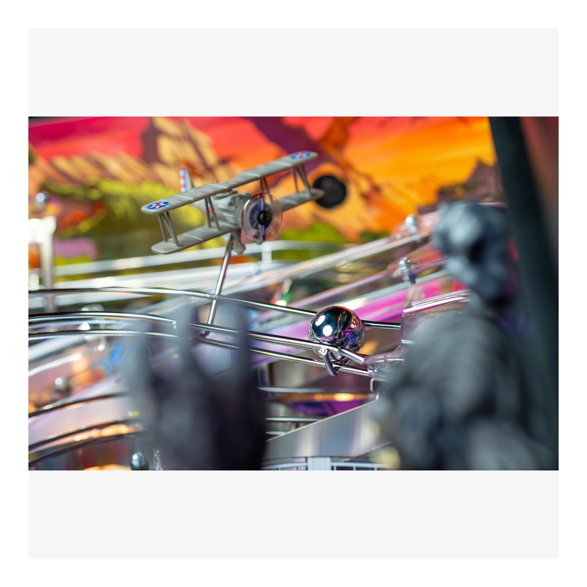 Pinball machine with a biplane figure and colorful background