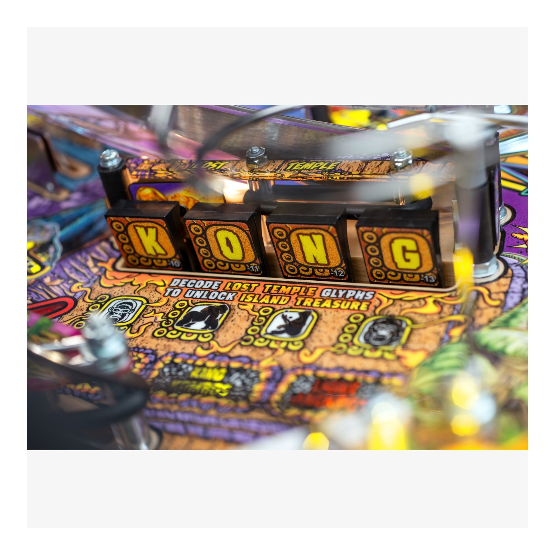 Close-up of a pinball machine with 'Kong' text and colorful design.
