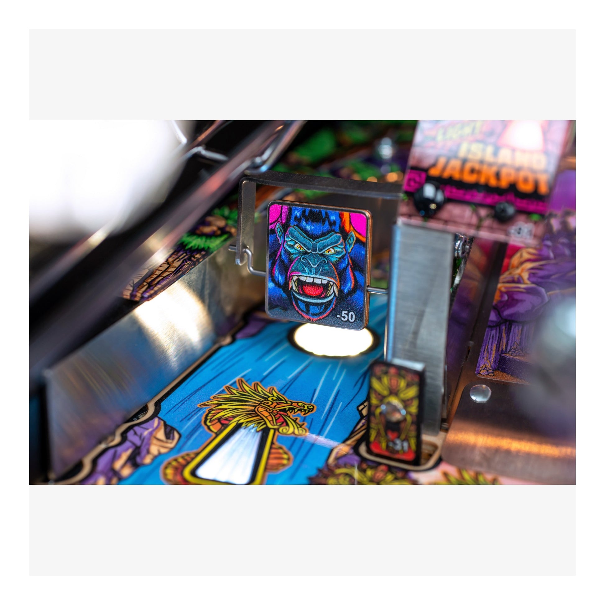 Close-up of a pinball machine with colorful artwork and text.