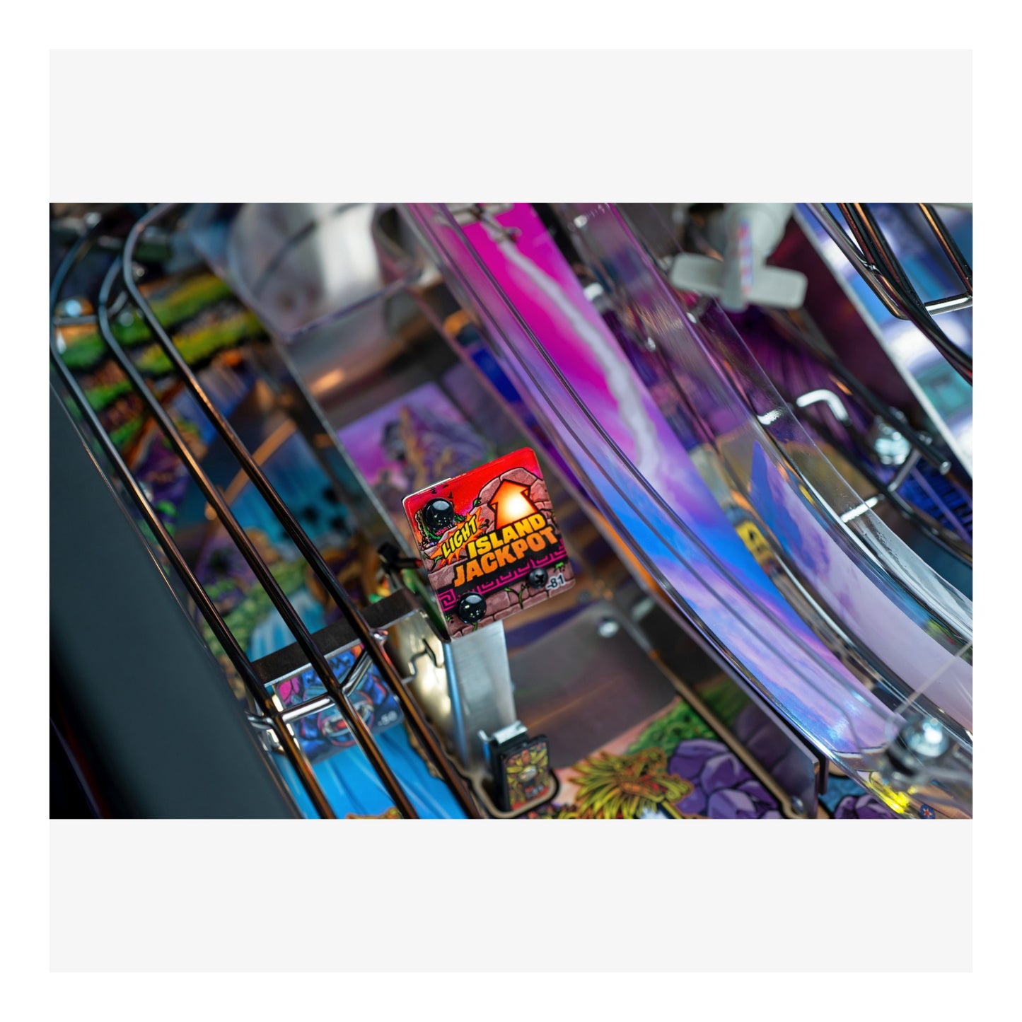 Close-up of a colorful pinball machine with a 'Hot Land Jackpot' ticket.