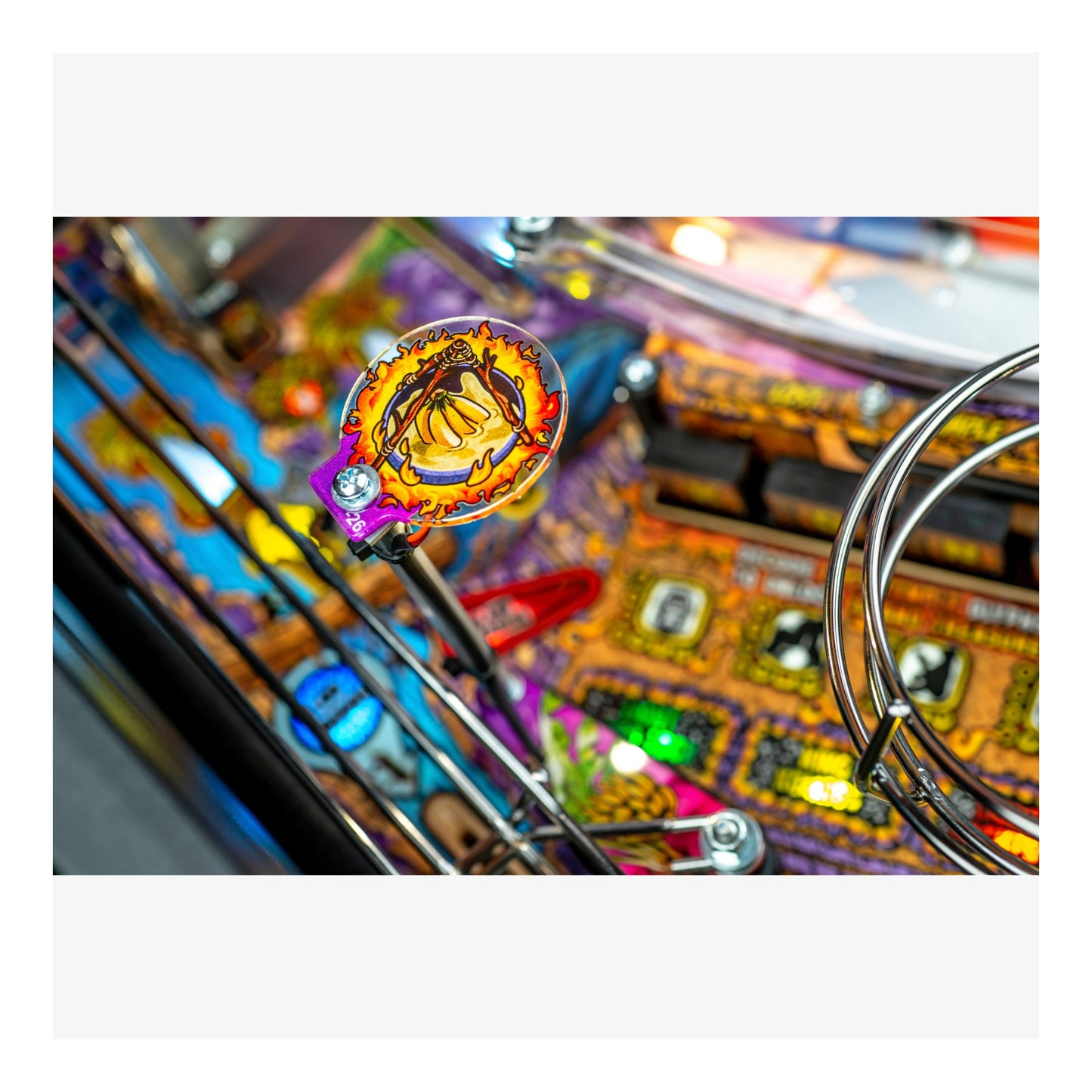 Close-up of a colorful pinball machine with vibrant lights and details.