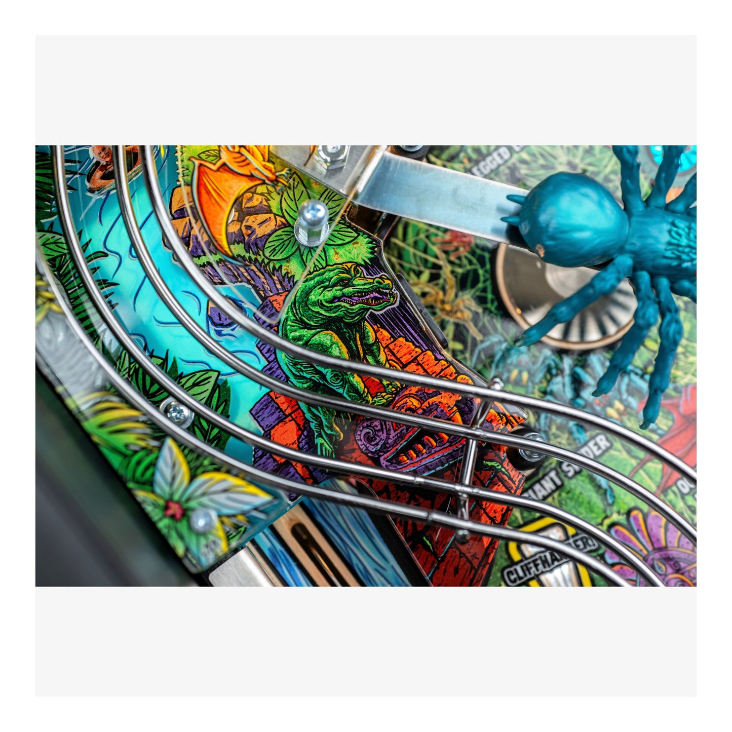 Colorful pinball machine with detailed artwork and a blue spider figure.