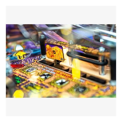 Close-up of a colorful pinball machine with vibrant lights and details.