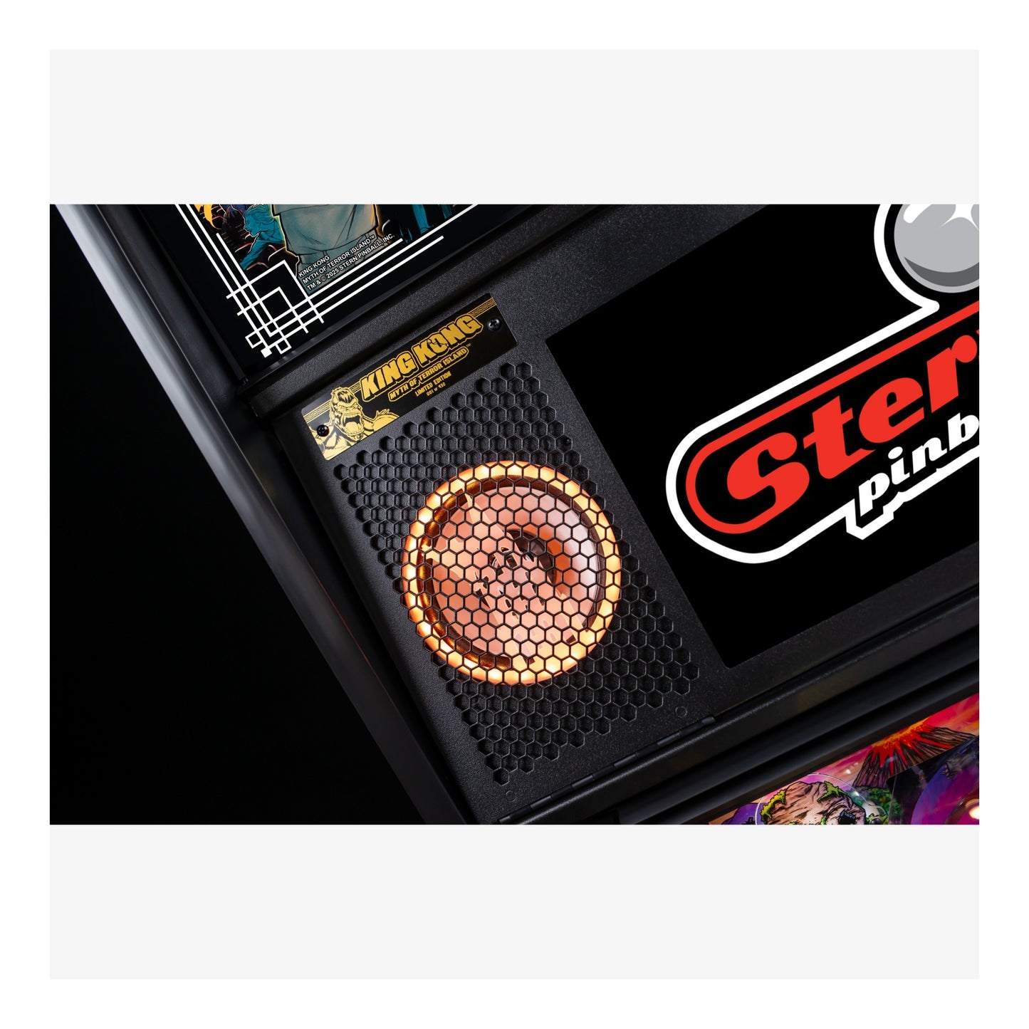 Close-up of a Stern Pinball machine with a King Kong card in the background