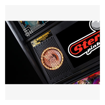 Close-up of a Stern Pinball machine with a King Kong card in the background