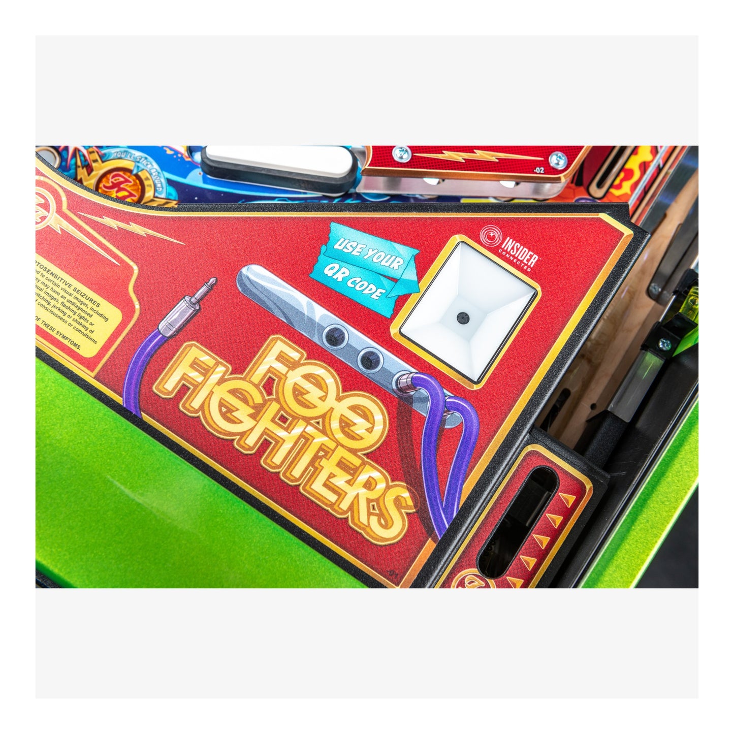 Pinball machine with 'Foo Fighters' branding on a red background