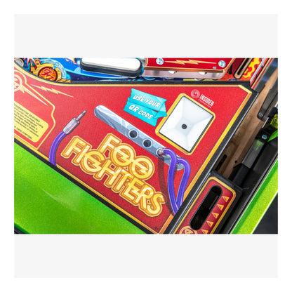 Pinball machine with 'Foo Fighters' branding on a red background