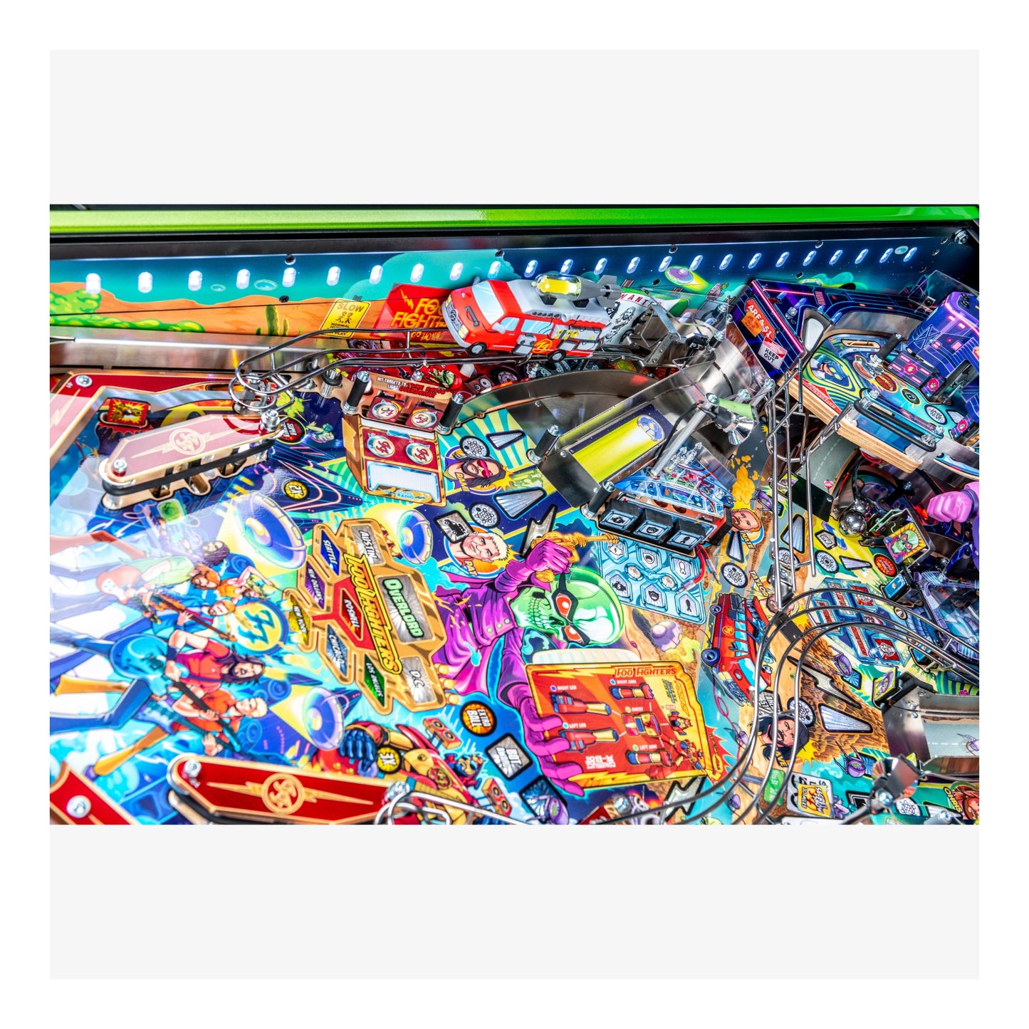 Colorful pinball machine with various symbols and lights on a white background
