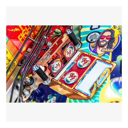 Close-up of a colorful pinball machine with various elements and branding.