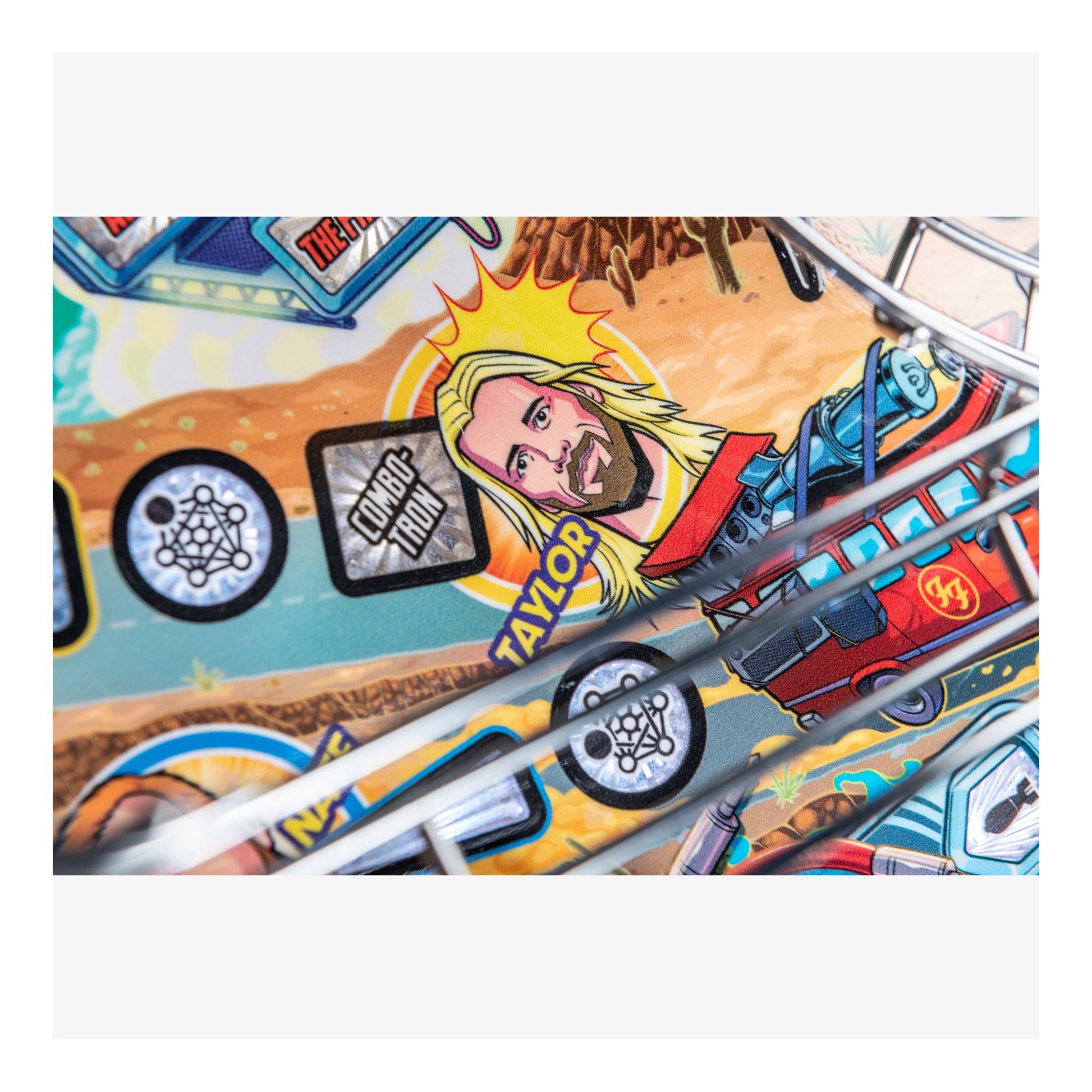 Close-up of a colorful pinball machine with various symbols and a prominent face.