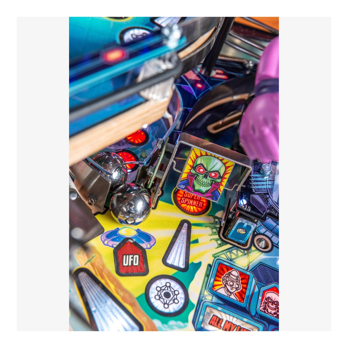 Close-up of a pinball machine with colorful artwork and symbols.