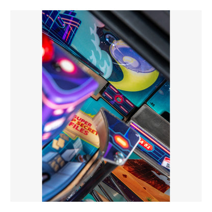 Close-up of a colorful pinball machine with various lights and text.