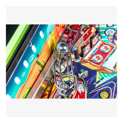 Close-up of a colorful pinball machine with vibrant graphics and metallic elements.