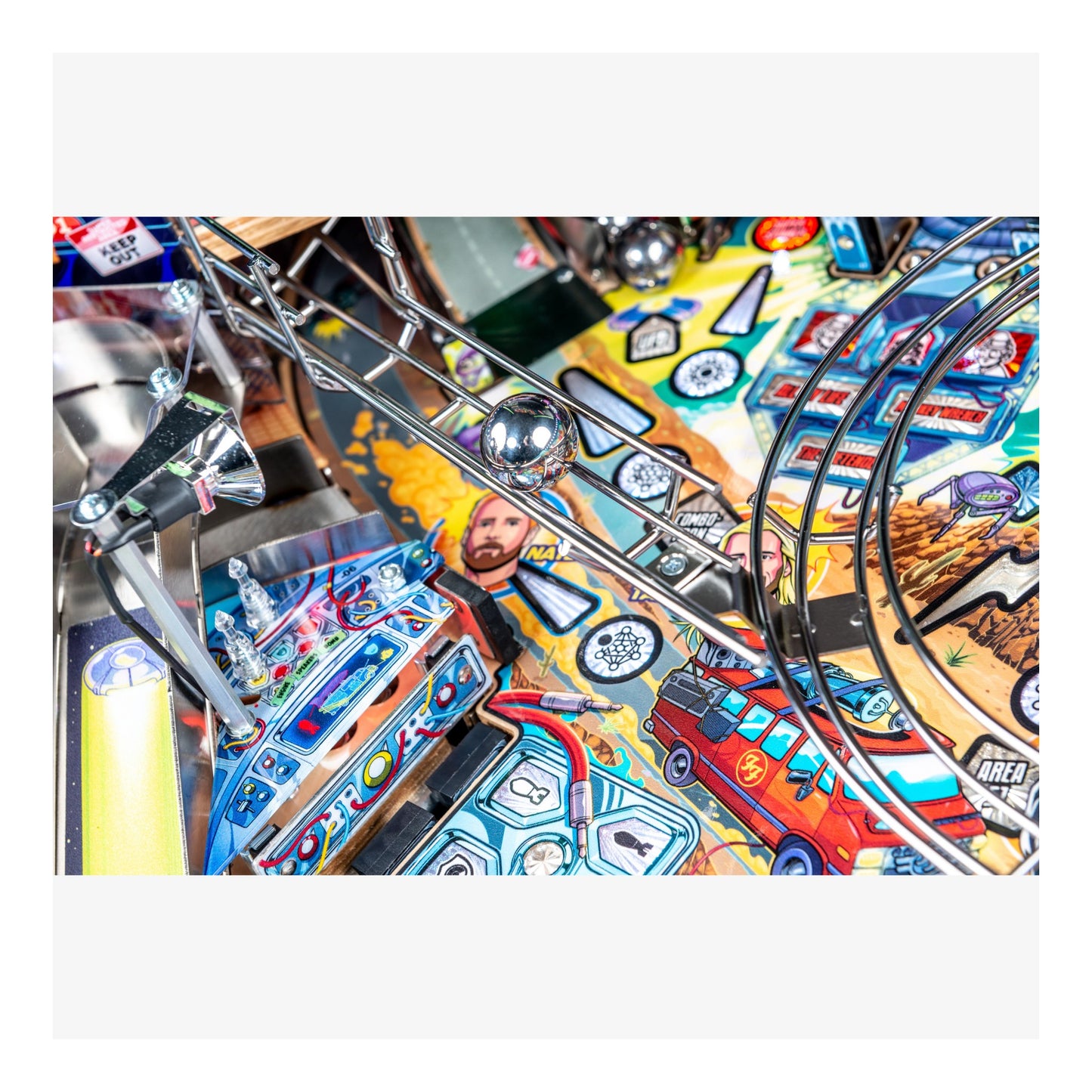 Close-up of a colorful pinball machine with various elements and graphics.