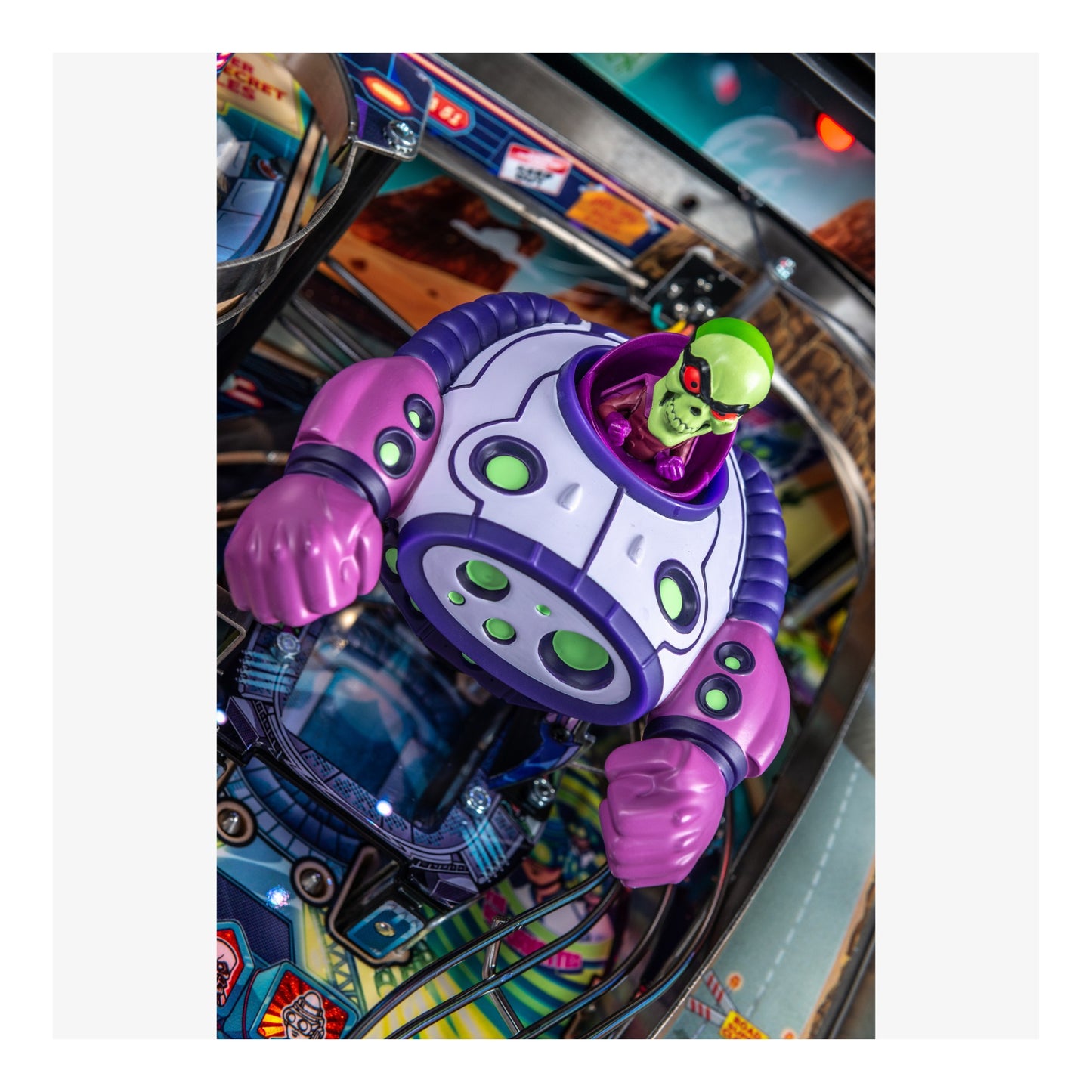 Colorful pinball machine with a robot figure and alien character