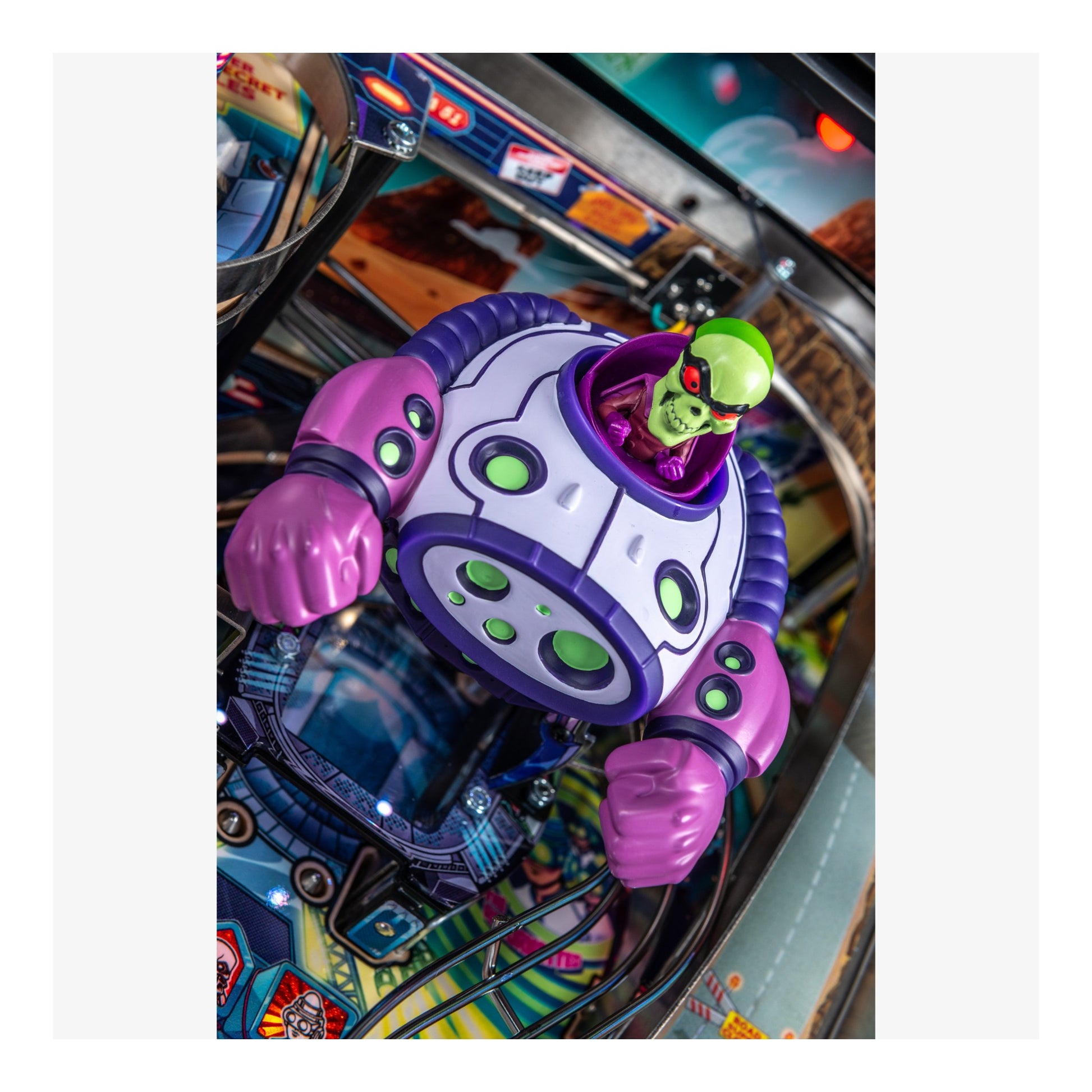 Colorful pinball machine with a robot figure and alien character