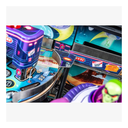 Close-up of a colorful pinball machine with vibrant graphics and neon lights.