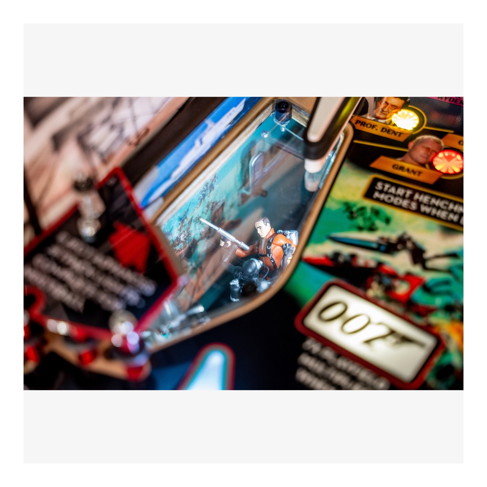 Close-up of a toy action figure set with a '007' theme on a white background.