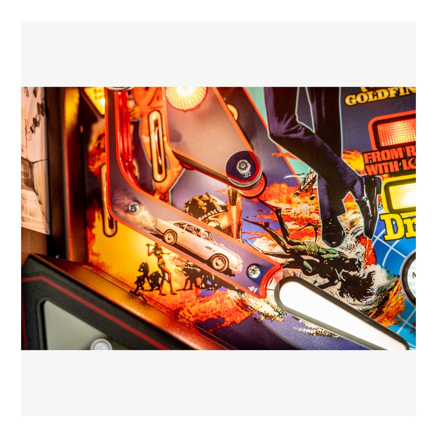 Close-up of a colorful pinball machine with vibrant graphics and bright lights.