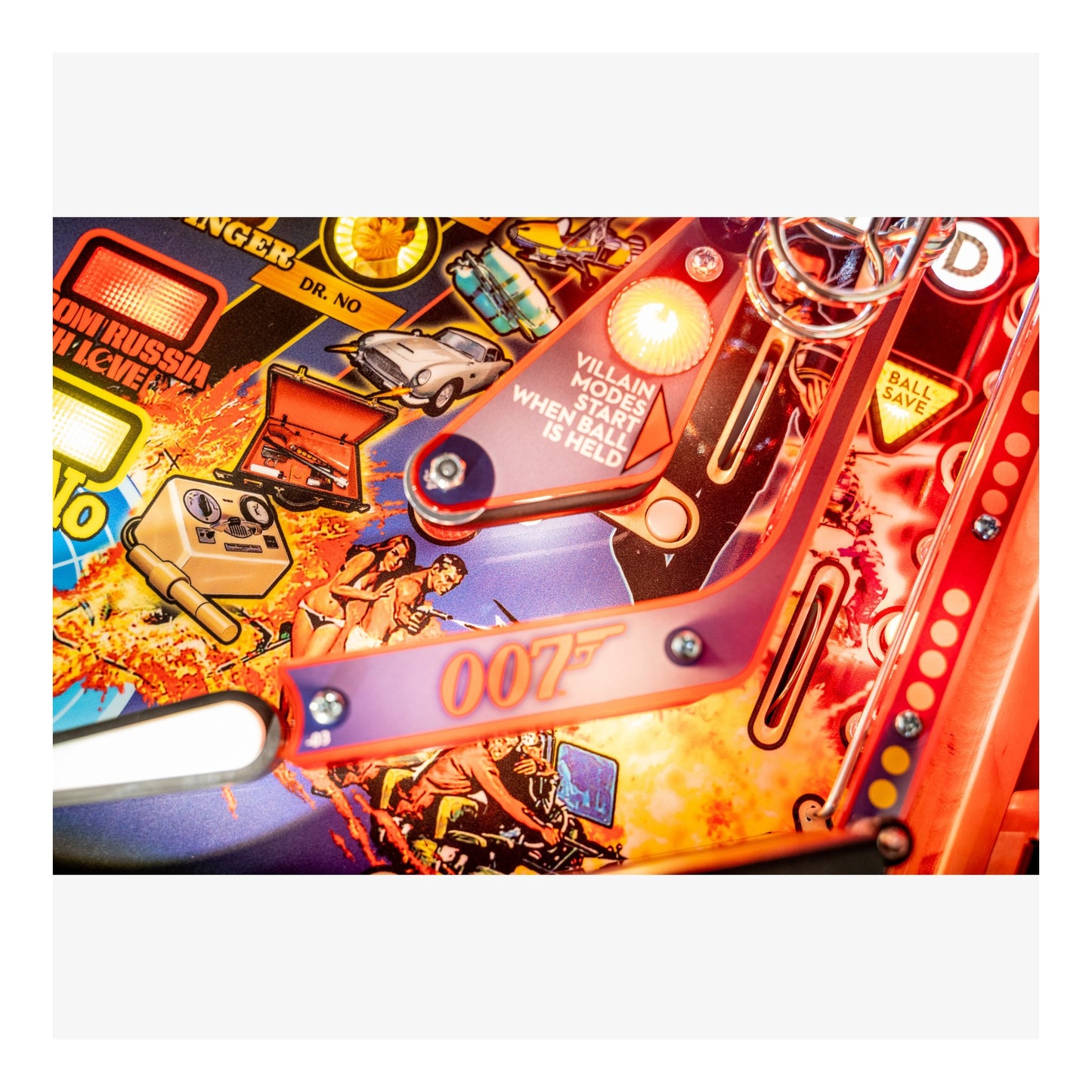 Close-up of a colorful pinball machine with '007' branding.