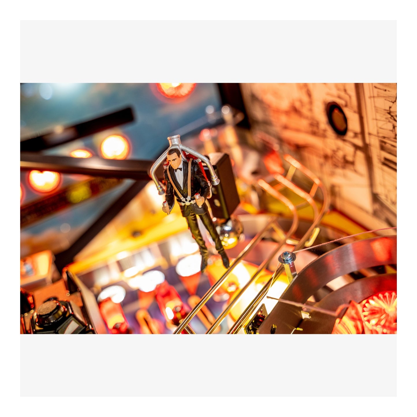 Toy figure on a mechanical model with colorful lights in the background