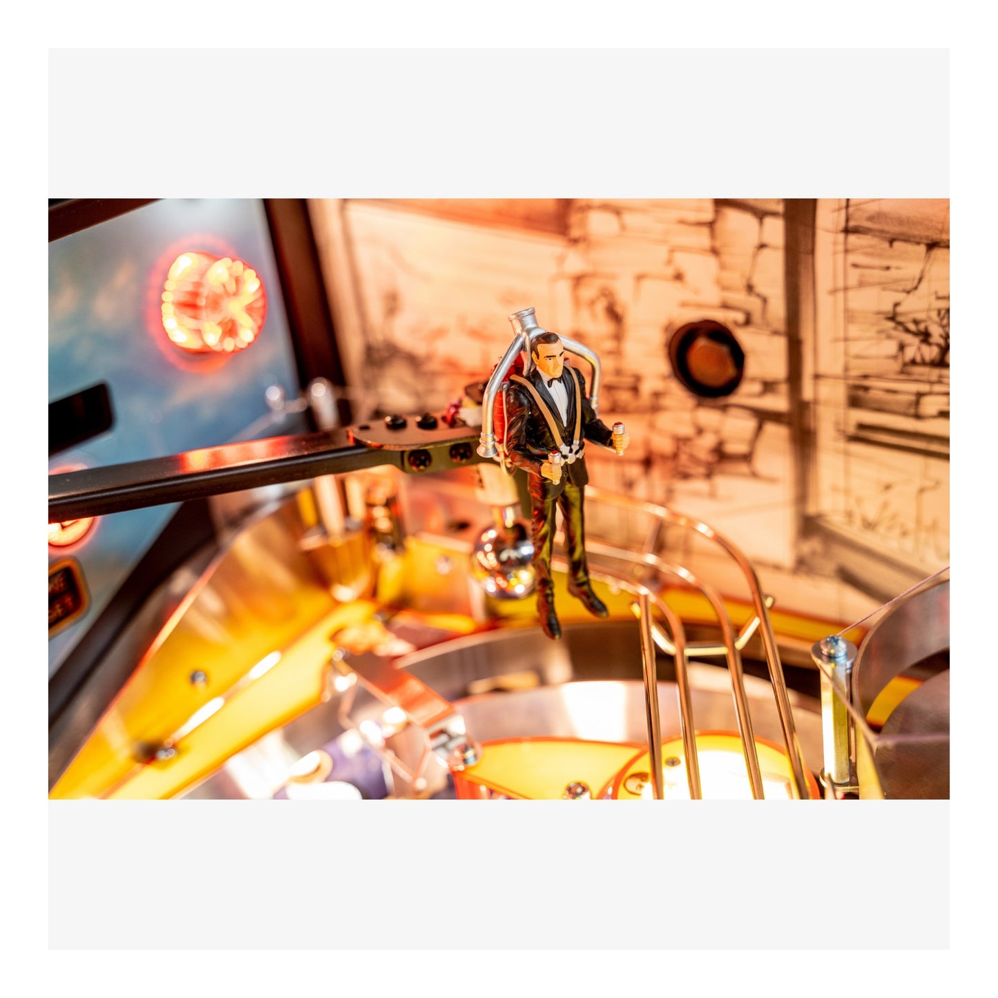 Close-up of a pinball machine with a player figure and colorful background