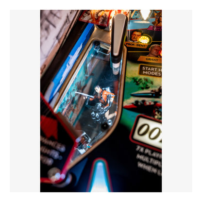 Close-up of a pinball machine with a player in the playfield
