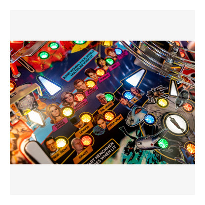 Close-up of a colorful pinball machine with various lights and characters.