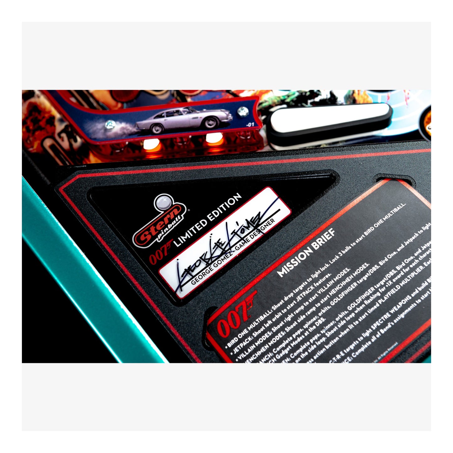 Close-up of a James Bond-themed pinball machine with a label and text.