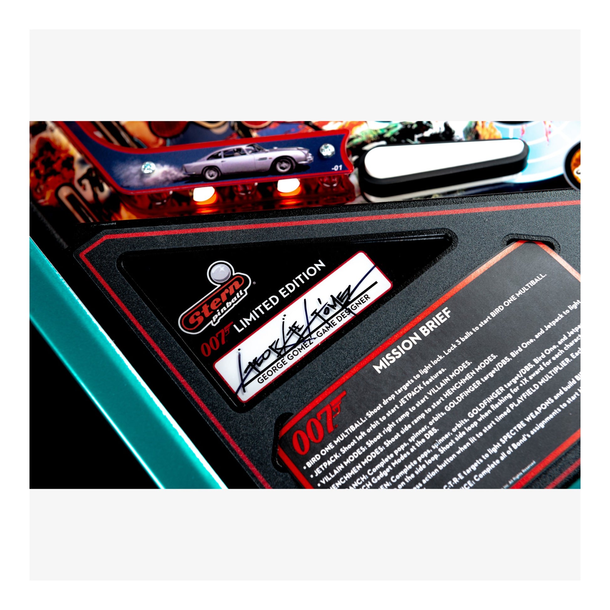 Close-up of a James Bond-themed pinball machine with a label and text.