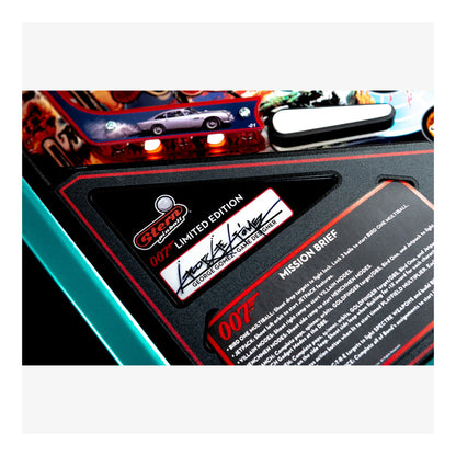 Close-up of a James Bond-themed pinball machine with a label and text.