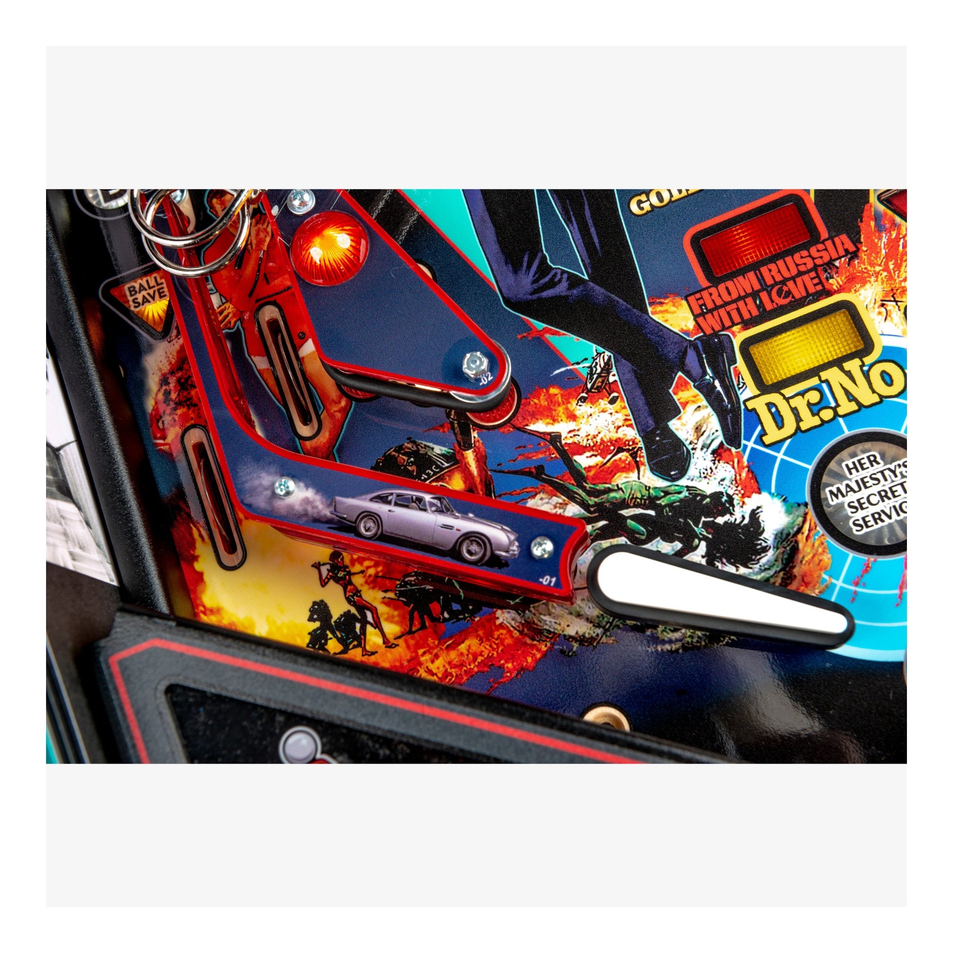 Close-up of a pinball machine with vibrant graphics and text, featuring a motorcycle and car scene.