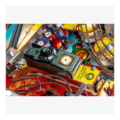 Close-up of a pinball machine with colorful artwork and mechanical components.