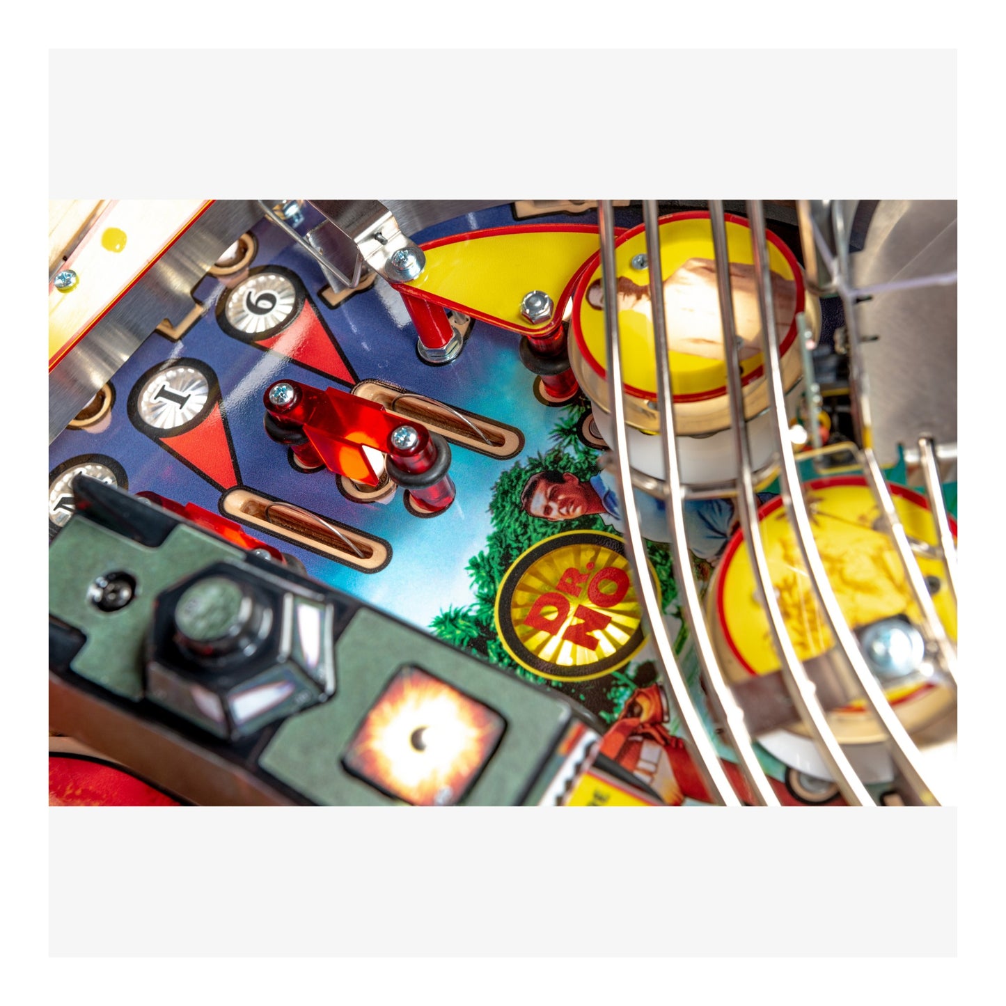 Close-up of a colorful pinball machine with various components.
