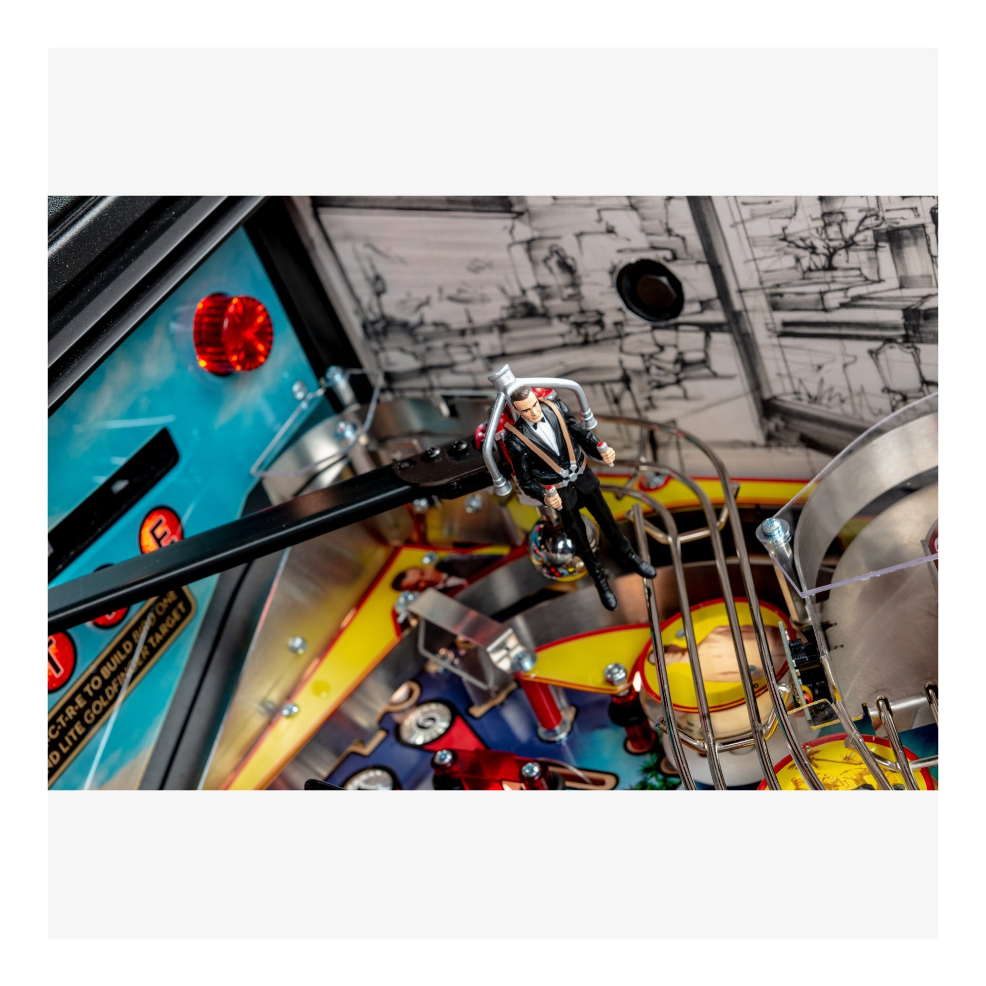 Close-up of a pinball machine with a player figure and colorful playfield.