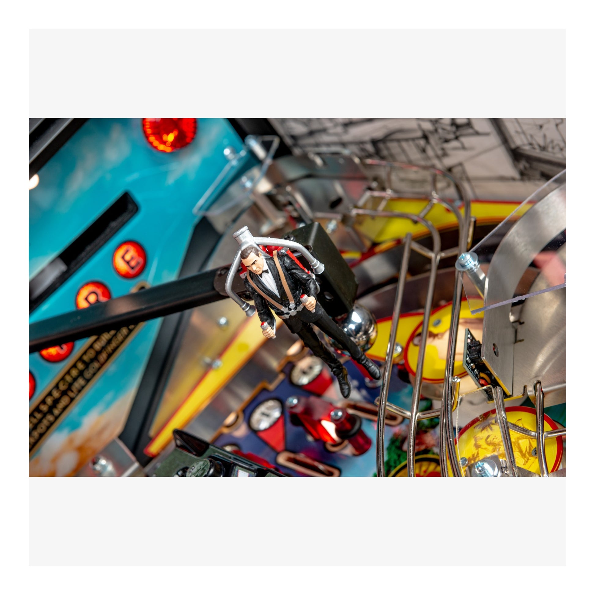 Close-up of a pinball machine with a player figure in action