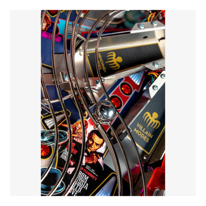 Close-up of a colorful pinball machine with various symbols and text.