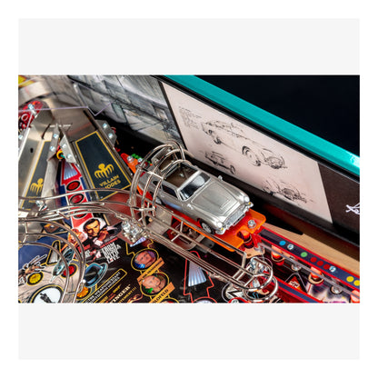 Close-up of a pinball machine with a car figure and colorful playfield