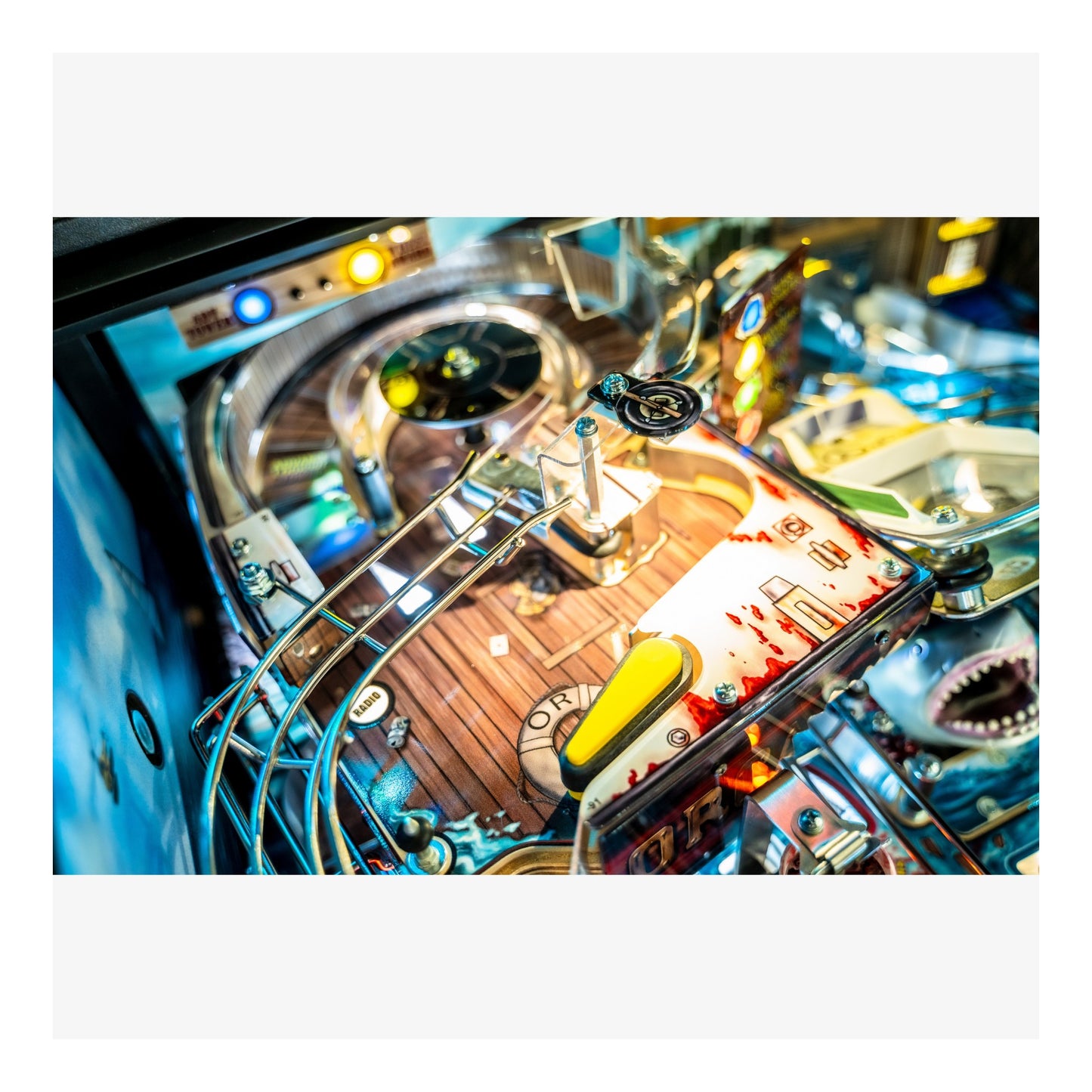 Close-up of a pinball machine with colorful lights and components.